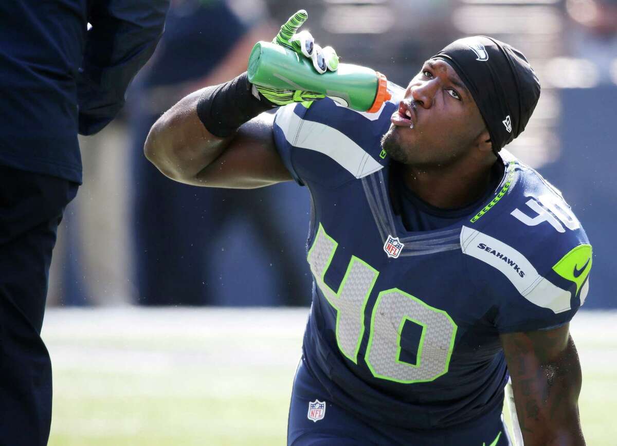 Seattle Seahawks' Derrick Coleman sips water before an NFL football game against the Denver Broncos, Sunday, Sept. 21, 2014, in Seattle.