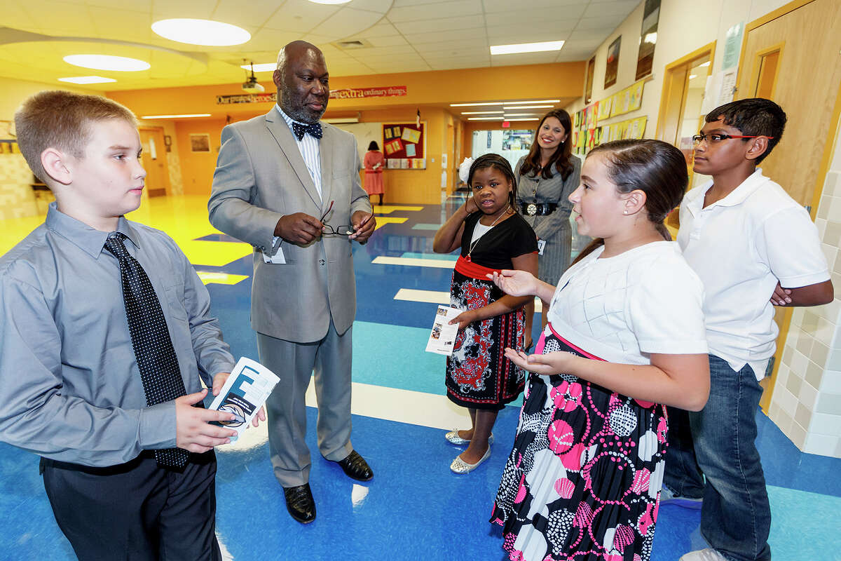 Texas Commissioner of Education Michael Williams (second from left) tours the new Rolling Meadows Elementary School at 17222 FM 2252 with the help of fifth grade student ambassadors Anil Saeed (10, from right), Sabrina Lagrimanta (10), Principal Erika Garza, Kelly Durham (10) and J.T. Priddy (10) on Wednesday, Sept. 4, 2013. Photo by Marvin Pfeiffer / Prime Time Newspapers