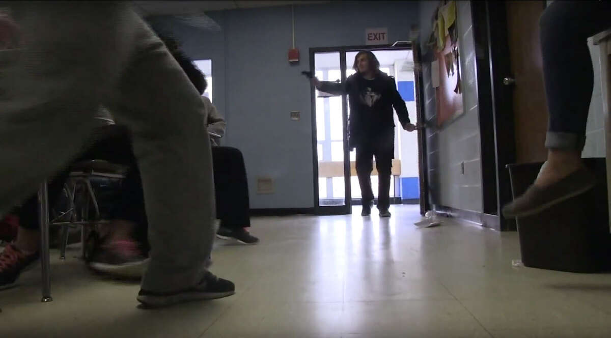 Role players act in an ALICE Training video. The program encourages an active civilian response to active shooters. In this scene, a shooter enters a classroom, and students quickly pelt him with whatever they have before dog piling. TIMELINE: A history of mass shooting in America ...