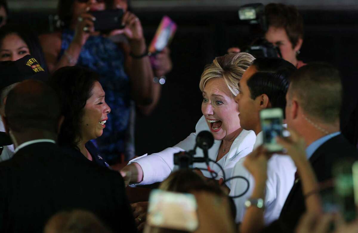 Presidential candidate Hillary Clinton, center, and Housing Secretary Julián Castro, right, greet supporters at a "Latinos for Hillary" rally at Sunset Station.