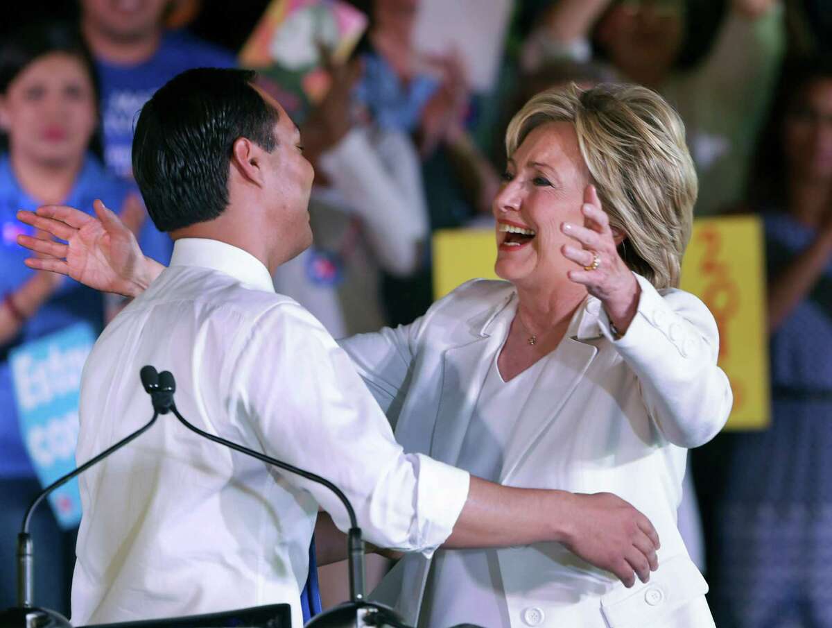 Presidential candidate Hillary Clinton, right, embraces Housing Secretary Julián Castro before she spoke to supporters at a rally at Sunset Station.