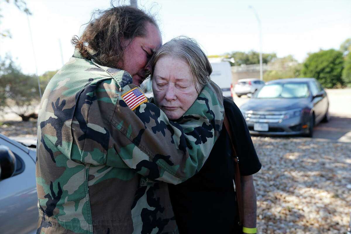 Smithville resident David Parrott consoles his weary and sleep-deprived mother, Sherry, over the loss of Sherry's home while awaiting to enter a shelter set up at the Smithville Recreation Center on Thursday, Oct. 15, 2015. Like the Parrotts, Bastrop County residents have dealt with evacuating their homes due to the Hidden Pines Fire. Firefighters continue to contain the flames that have now spread to more than 4,200 acres in Bastrop County according to the Texas A&M Forest Service. (Kin Man Hui/San Antonio Express-News)