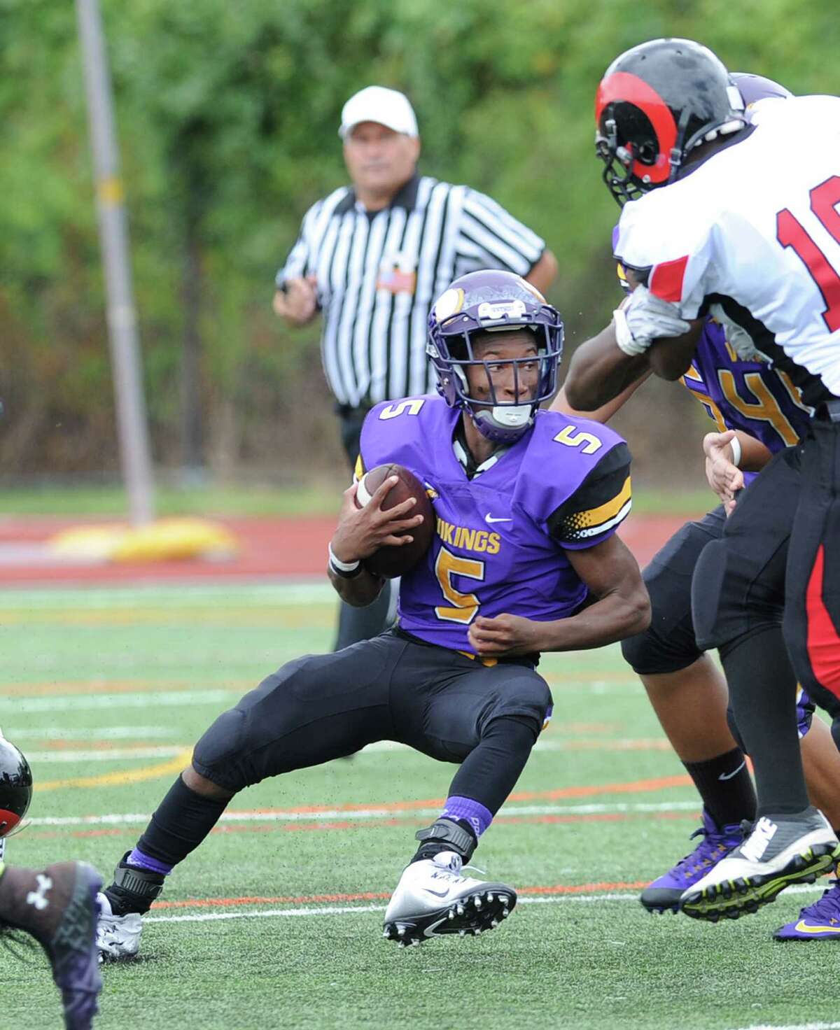 Westhill High football player Aaron Pettiford looks to gain ground against Bridgeport Central in Stamford on Sept. 12. Pettiford is on a kidney transplant waiting list at Yale.