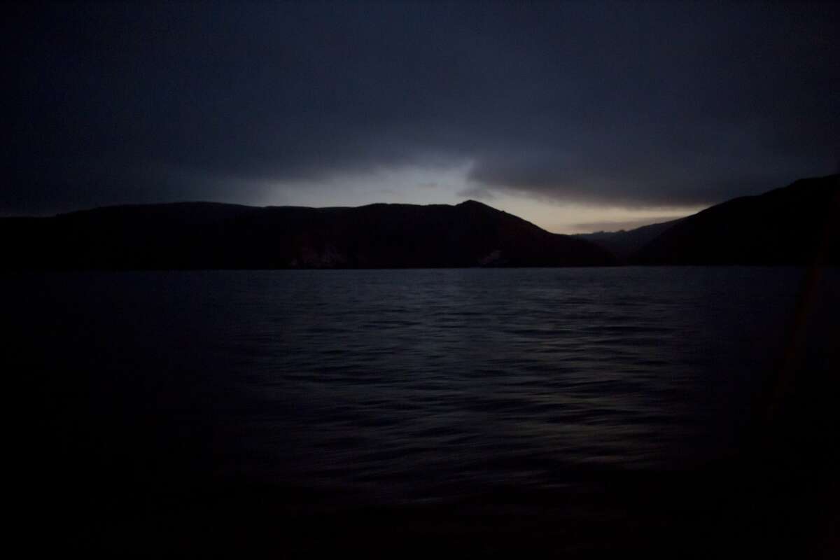 2015年10月7日，从米亚尼科尔渔船上看到的第一缕晨光出现在山脊上。(图片来源:Tim Hussin)