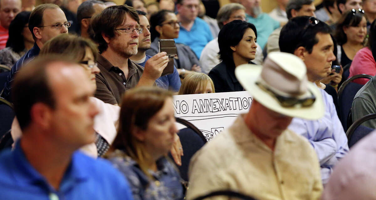 Bryan Vines (center left) and daughter Bryanna Vines attend the forum, where many called for preservation of their ways of life and many called for the right to vote on annexation.