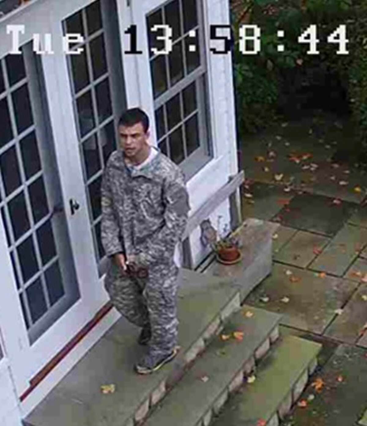 Photos from a surveillance camera show a suspect during a burglary in Roxbury on Tuesday.