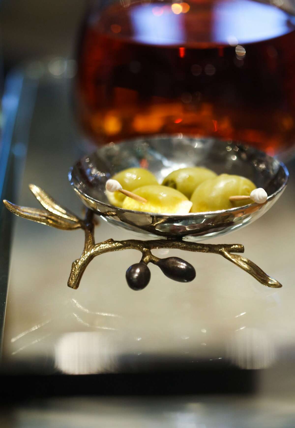 Olives rest in an olive tray on a bar cart styled by designer Tineke Triggs in San Francisco.