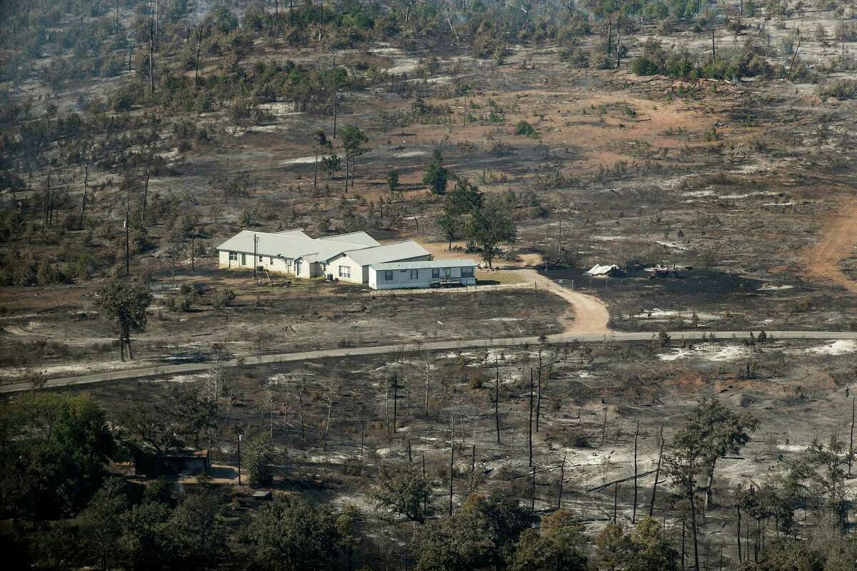 In this aerial photo, a home surrounded by burned landscape appearsspared from the Hidden Pines Fire near Smithville, Texas, Friday, Oct. 16, 2015. A preliminary investigation indicates a farming accident sparked the wildfire that's consumed more than 7 square miles and destroyed 40 structures in Central Texas, authorities said Friday. (Rodolfo Gonzalez/Austin American-Statesman via AP) AUSTIN CHRONICLE OUT, COMMUNITY IMPACT OUT, INTERNET AND TV MUST CREDIT PHOTOGRAPHER AND STATESMAN.COM, MAGS OUT; MANDATORY CREDIT