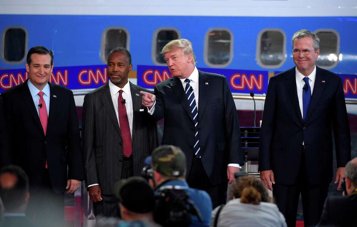 Republican presidential candidates, from left, Sen. Ted Cruz, Ben Carson, Donald Trump, and former Florida Gov. Jeb Bush pose for a group picture during the CNN Republican presidential debate at the Ronald Reagan Presidential Library and Museum, Wednesday, Sept. 16, 2015, in Simi Valley, Calif. (AP Photo/Mark J. Terrill)