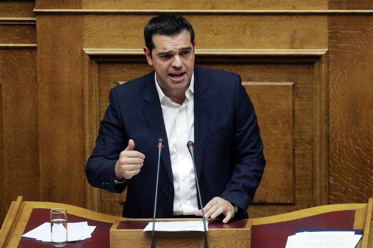 Greek Prime Minister Alexis Tsipras addresses lawmakers at the Greek parliament in Athens on October 16, 2015, as Greece's parliament is expected to approve later a first batch of reforms and tax cuts stemming from its third EU bailout. The vote, scheduled for around midnight, is expected to be won by the leftist government of Prime Minister Alexis Tsipras, which has 155 lawmakers in the 300-seat chamber. AFP PHOTO / LOUISA GOULIAMAKILOUISA GOULIAMAKI/AFP/Getty Images
