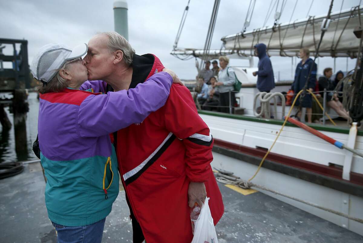 Linda Nowell gives her husband Keith Nowell a good luck kiss before he competes in his 25th Escape From Alcatraz triathlon at Aquatic Park in San Francisco, Calif. on Saturday, Oct. 17, 2015. Race organizers from the Dolphin Club took extra precautions for this year's event, including additional pilot boats, after great white shark sightings in the bay in recent weeks.