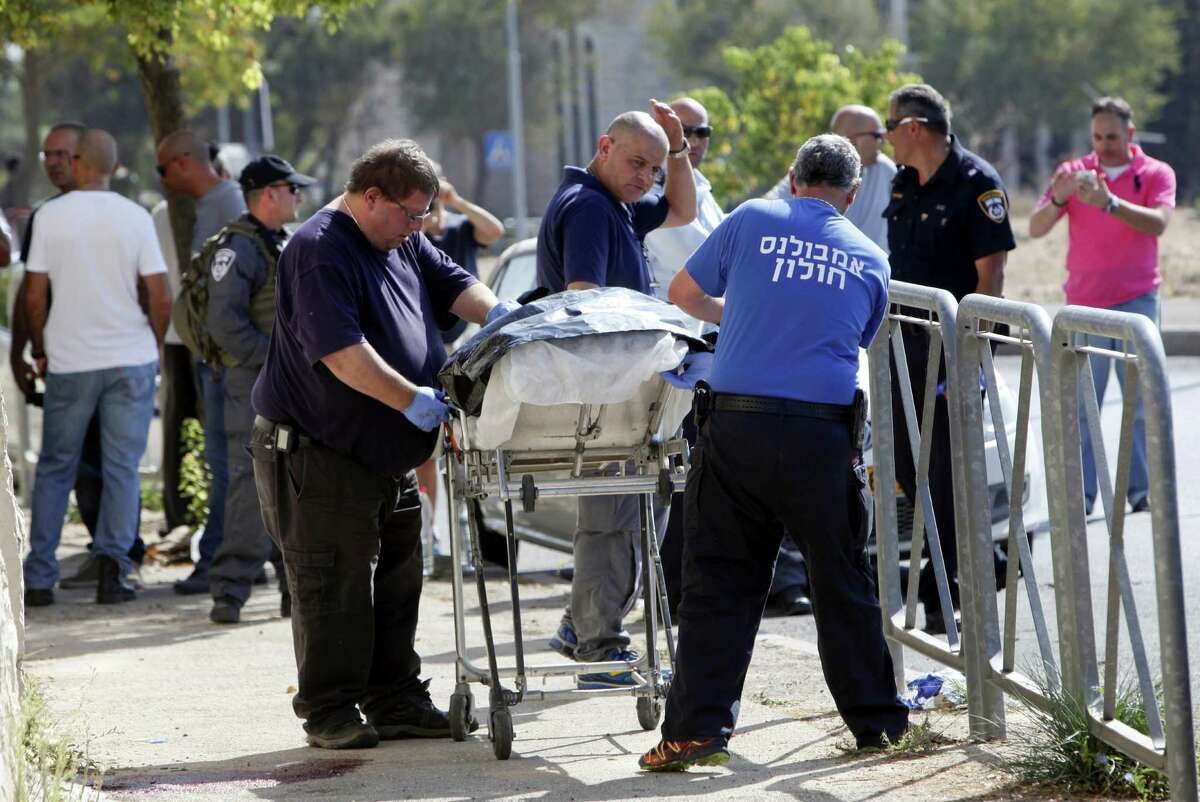 The body of a﻿ Palestinian ﻿teen is removed from the scene of an alleged attack Saturday in Jerusalem﻿. Police spokeswoman Luba Samri said a 16-year-old Palestinian drew a knife on officers when they approached him ﻿and asked for identification﻿. She said the officers opened fire and killed him.﻿