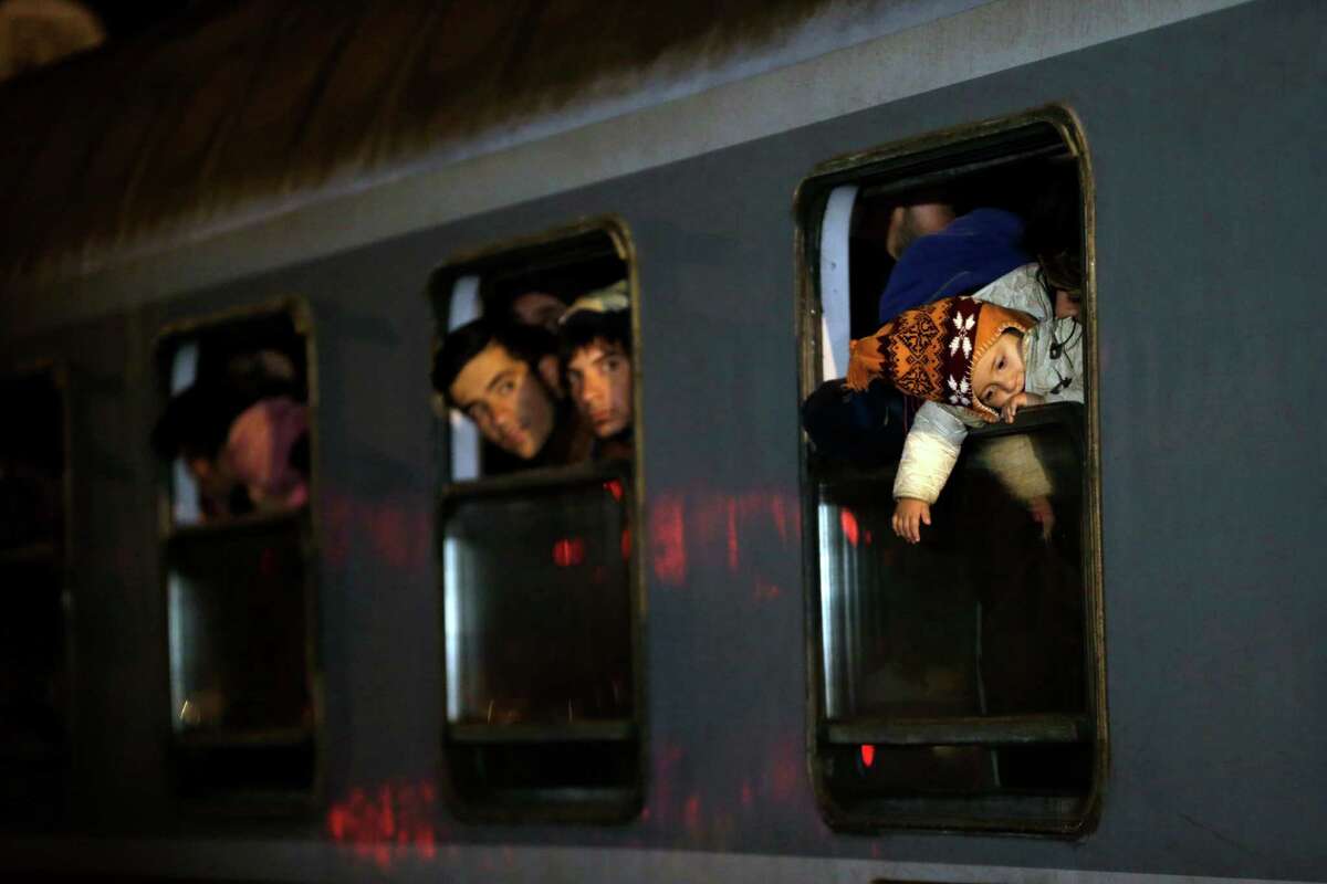 Migrants look at of a train as they arrive from Croatia in Sredisce ob Dravi, Slovenia, Saturday, Oct. 17, 2015. Hungary shut down its border with Croatia to the free flow of migrants, prompting Croatia to redirect thousands of people toward its border with Slovenia. (AP Photo/Petr David Josek)