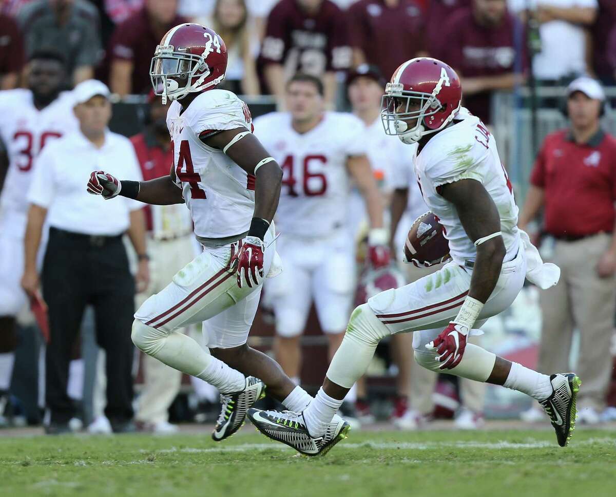 Eddie Jackson, right, makes his way to the end zone with one of the three interceptions of Kyle Allen that the Crimson Tide returned for touchdowns.