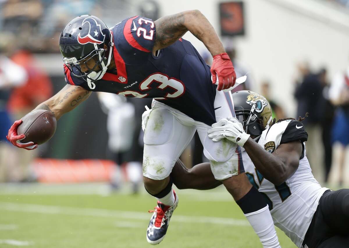 Houston Texans running back Arian Foster (23) pulls away from Jacksonville Jaguars strong safety Johnathan Cyprien (37) as he crosses the goal line for a 14-yard touchdown reception during the first quarter of an NFL football game at EverBank Field on Sunday, Oct. 18, 2015, in Jacksonville. ( Brett Coomer / Houston Chronicle )