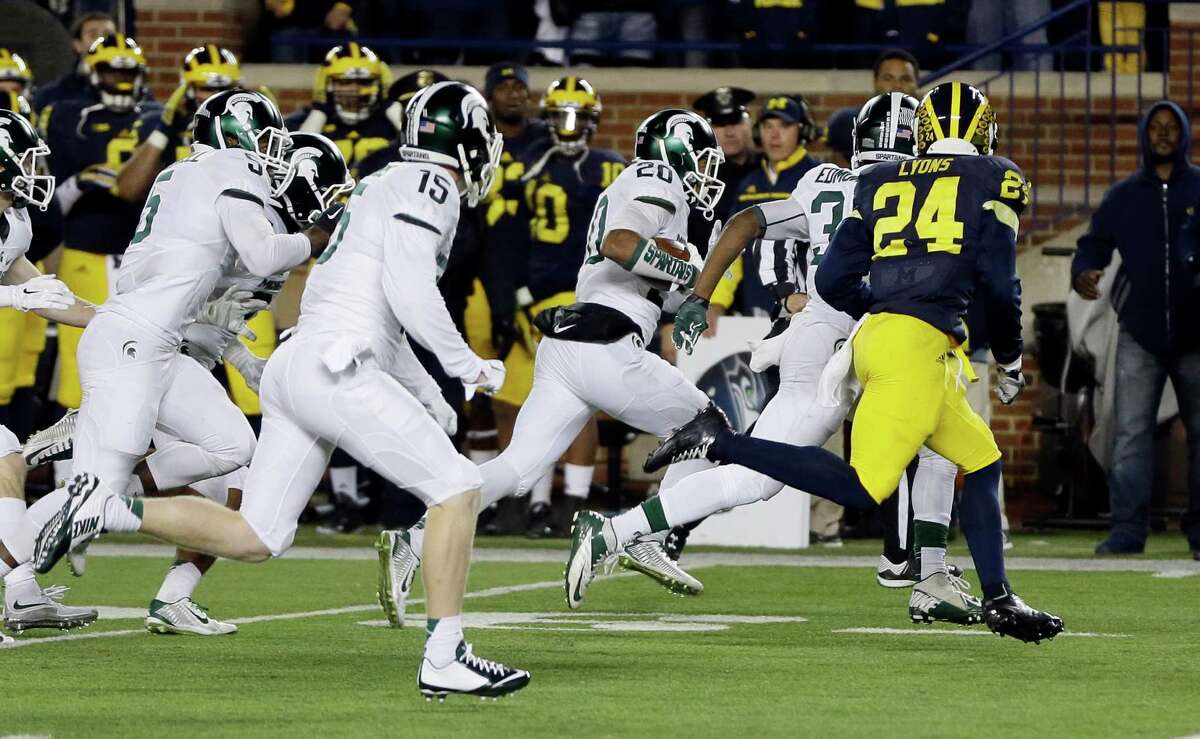 Michigan State defensive back Jalen Watts-Jackson (20) runs towards the end zone after recovering a fumbled snap on a punt in the closing seconds of the second half of an NCAA college football game, Saturday, Oct. 17, 2015, in Ann Arbor, Mich. Watts-Jackson lumbered 38 yards for a touchdown on the final play of the game, giving No. 7 Michigan State a shocking 27-23 win over No. 12 Michigan(AP Photo/Carlos Osorio)