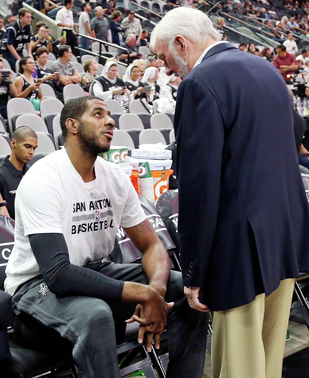Spurs' LaMarcus Aldridge talks with head coach Gregg Popovich before the game with the Pistons Sunday Oct. 18, 2015 at the AT&T Center.