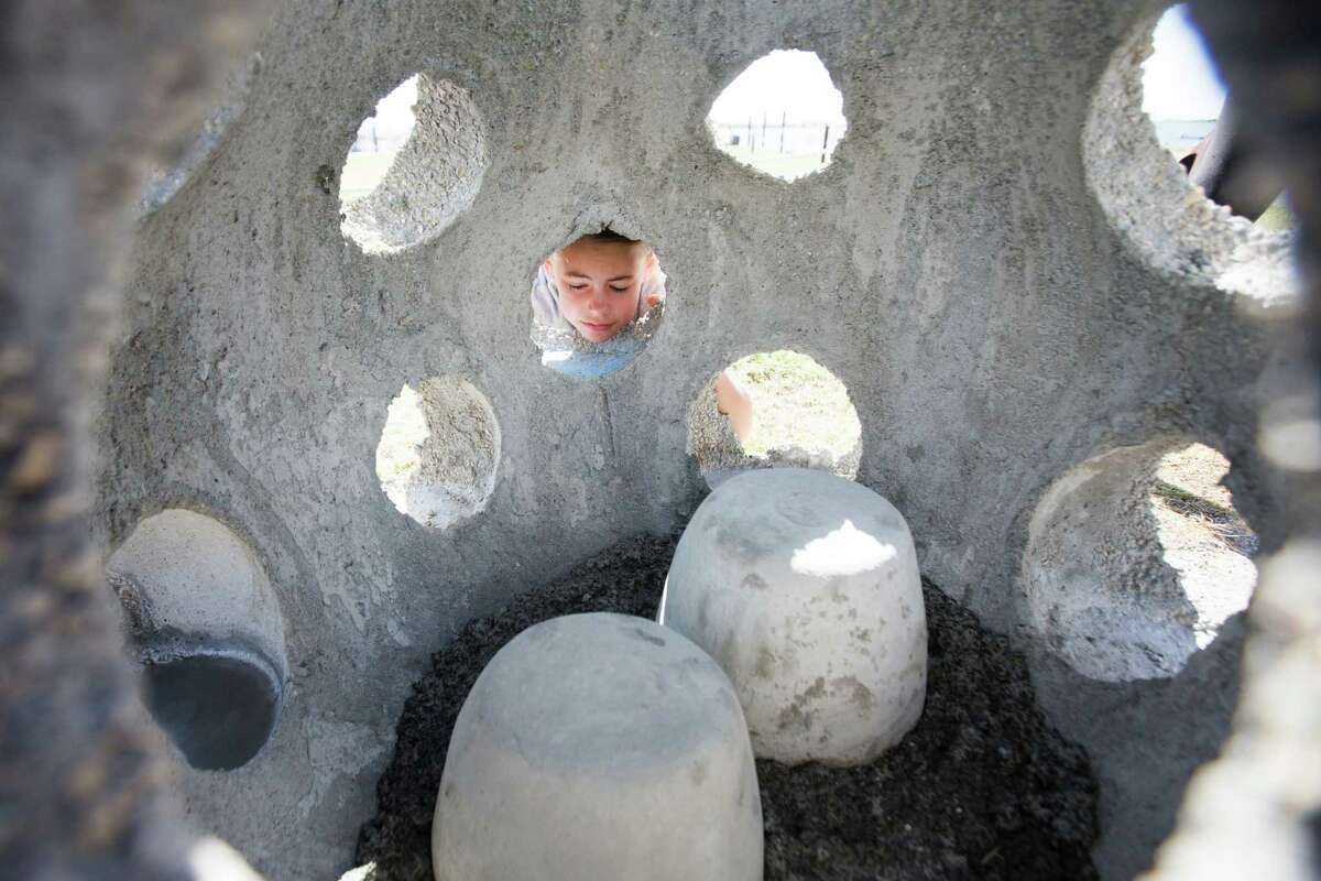Heather Hadley, 9, takes a look inside an Eternal Reef where the two cremation urns of her great-grandparents Dick Gabler and Helen Gabler are secured to be placed in the Gulf of Mexico. near Galveston. The Eternal Reefs Memorial gives the opportunity to the family members to participate in the memorialization of the loved one and to create a healthier aquatic ecosystems. Sunday, Oct. 18, 2015, in Galveston. ( Marie D. De Jesus / Houston Chronicle )