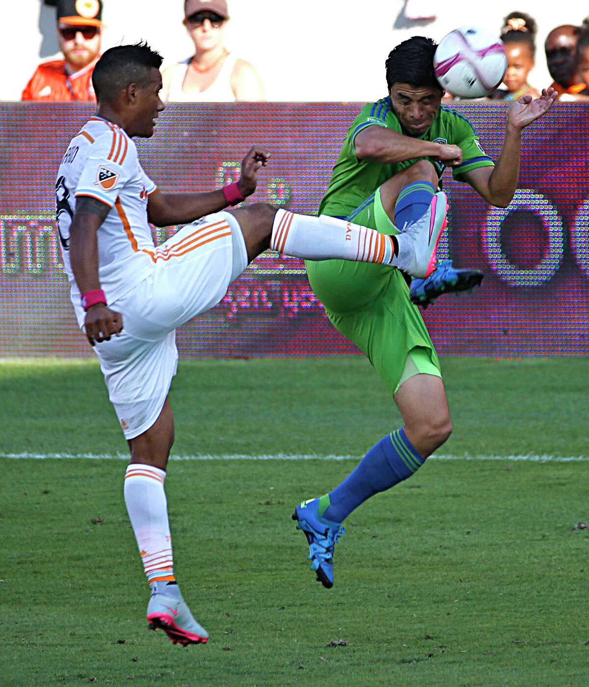 The cleats get dangerously high as the Dynamo's Luis Garrido, left, and the Sounders' Gonzalo Pineda clash.