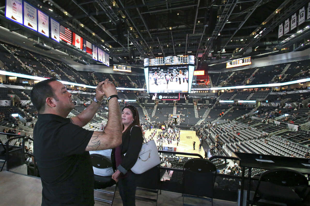 Rene Velasquez takes pictures as the newly renovated AT&T Center is opened to Spurs fans for the first time. A reader says the funds used to remodel the facility could have been put to better use.
