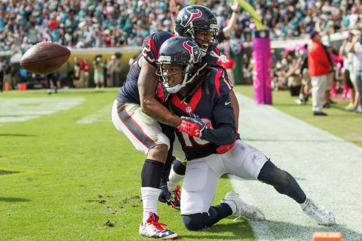 Arian Foster, left, joins DeAndre Hopkins to celebrate the first of Hopkins' two touchdown catches Sunday, a 9-yarder in the fourth quarter.