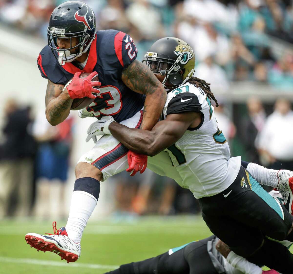 Texans running back Arian Foster reaches the end zone in the first quarter despite a hit by Jaguars safety Johnathan Cyprien.