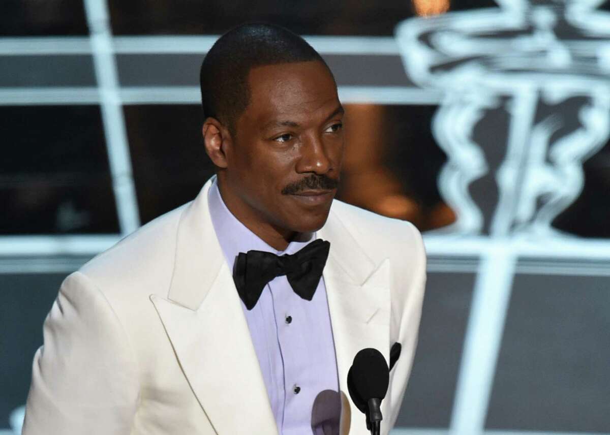 FILE - In this Feb. 22, 2015 file photo, Eddie Murphy presents the award for best original screenplay at the Oscars at the Dolby Theatre in Los Angeles. Chris Rock, Kathy Griffin, Arsenio Hall and other leading comedians will perform Sunday, Oct. 18, in honor of Murphy as he receives the nationâs top prize for humor, the the Mark Twain Prize for American Humor, at the Kennedy Center in Washington. (Photo by John Shearer/Invision/AP, File)
