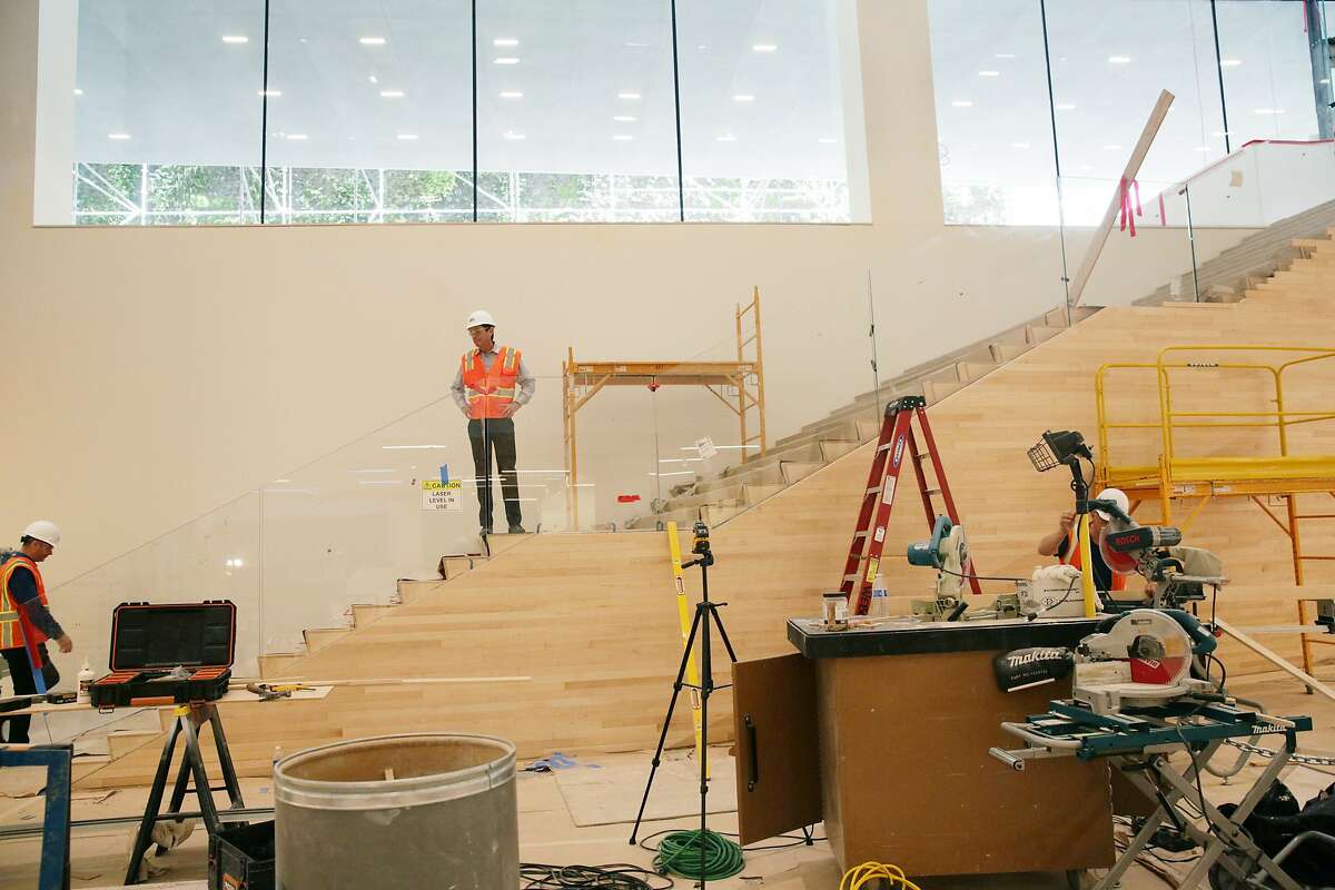 San Francisco Museum of Modern Art director Neal Benezra (right) stands on stairs in Schwab Hall as lead architect Craig Dykers (left) climbs the first step in the San Francisco Museum of Modern Art during it's expansion on Thursday, October 8, 2015 in San Francisco, Calif. Schwab Hall will be a central gathering point and ticketing area.