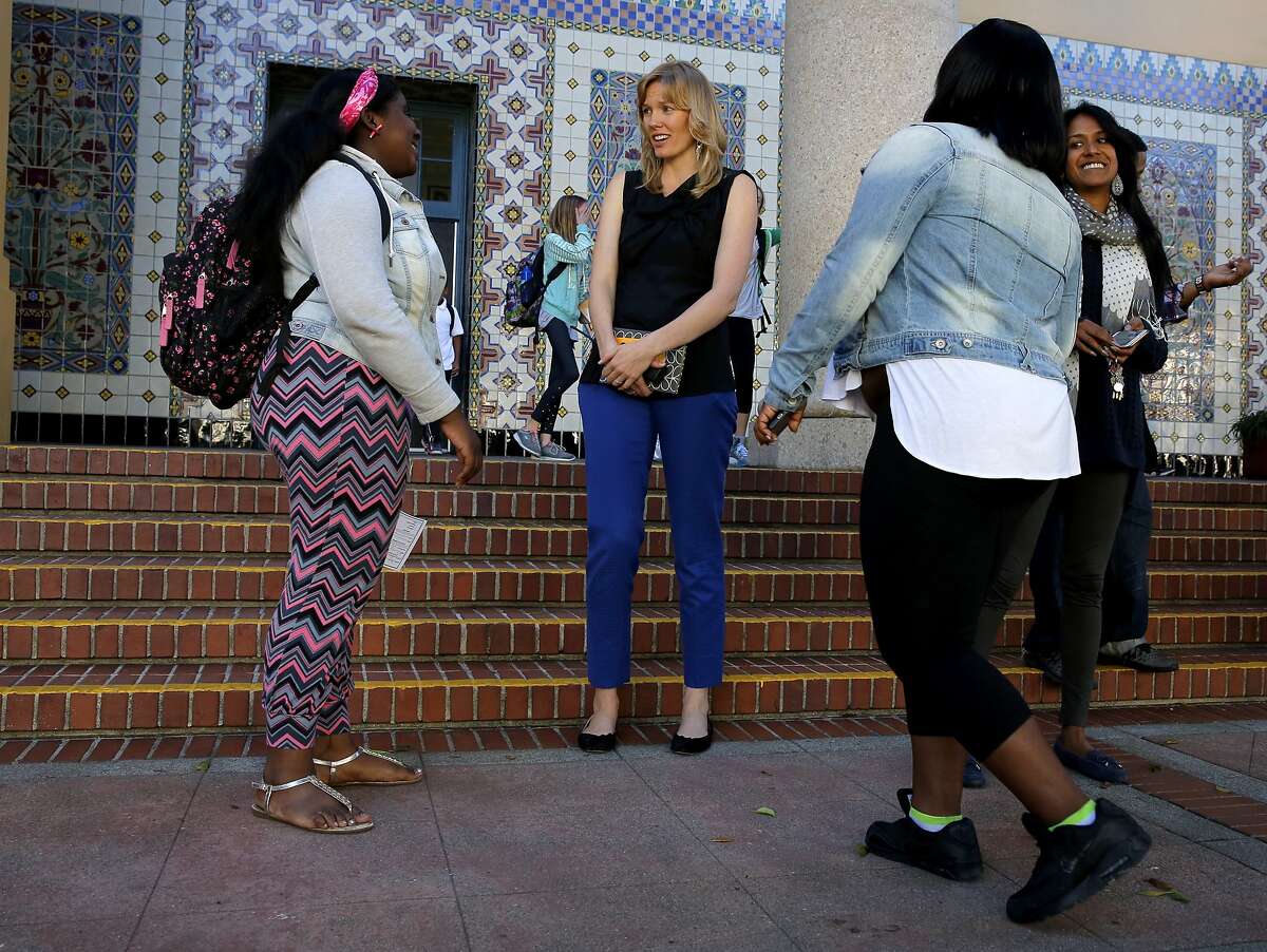 Principal Lena Van Haren (center) chats with former students Kayla Rash (left) and Honesty Williams outside Everett Middle School in San Francisco, California, on Monday, Oct. 19, 2015.