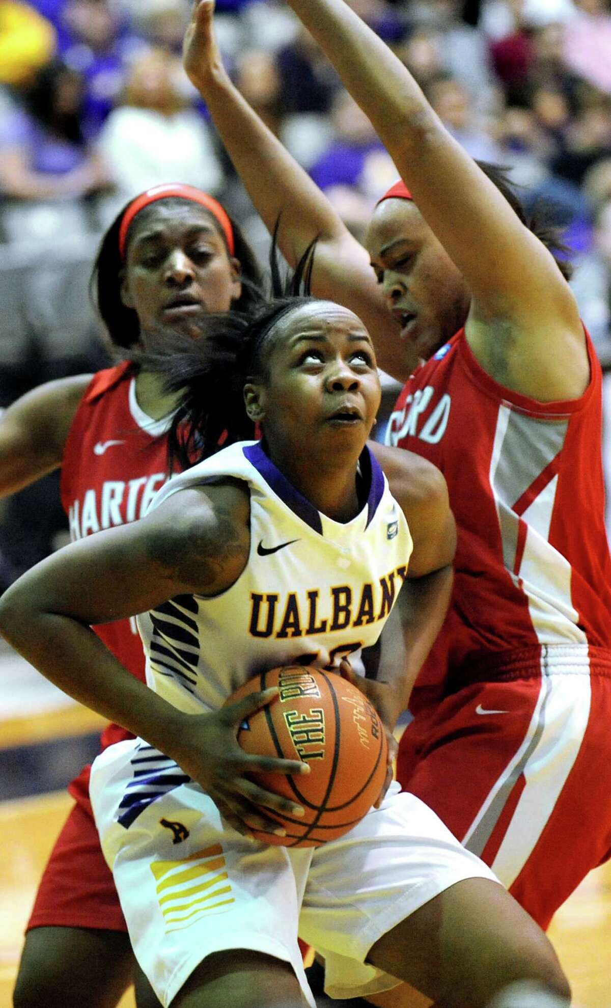 UAlbany's Imani Tate, center, looks to the hoop as Hartford's La'Trice Hall, left, and Cherelle Moore defend during their America East Championship game on Friday, March 13, 2015, at UAlbany in Albany, N.Y. (Cindy Schultz / Times Union)