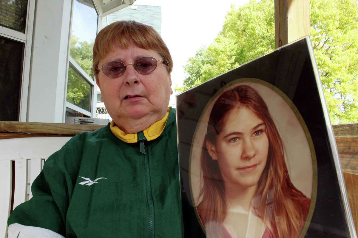 Carolyn Tousignant holds a photo of her daughter Carrie Ann Jopek at her home on Monday in Milwaukee. The seventh-grader disappeared in March 1982. A 50-year-old man is now being charged in her death.
