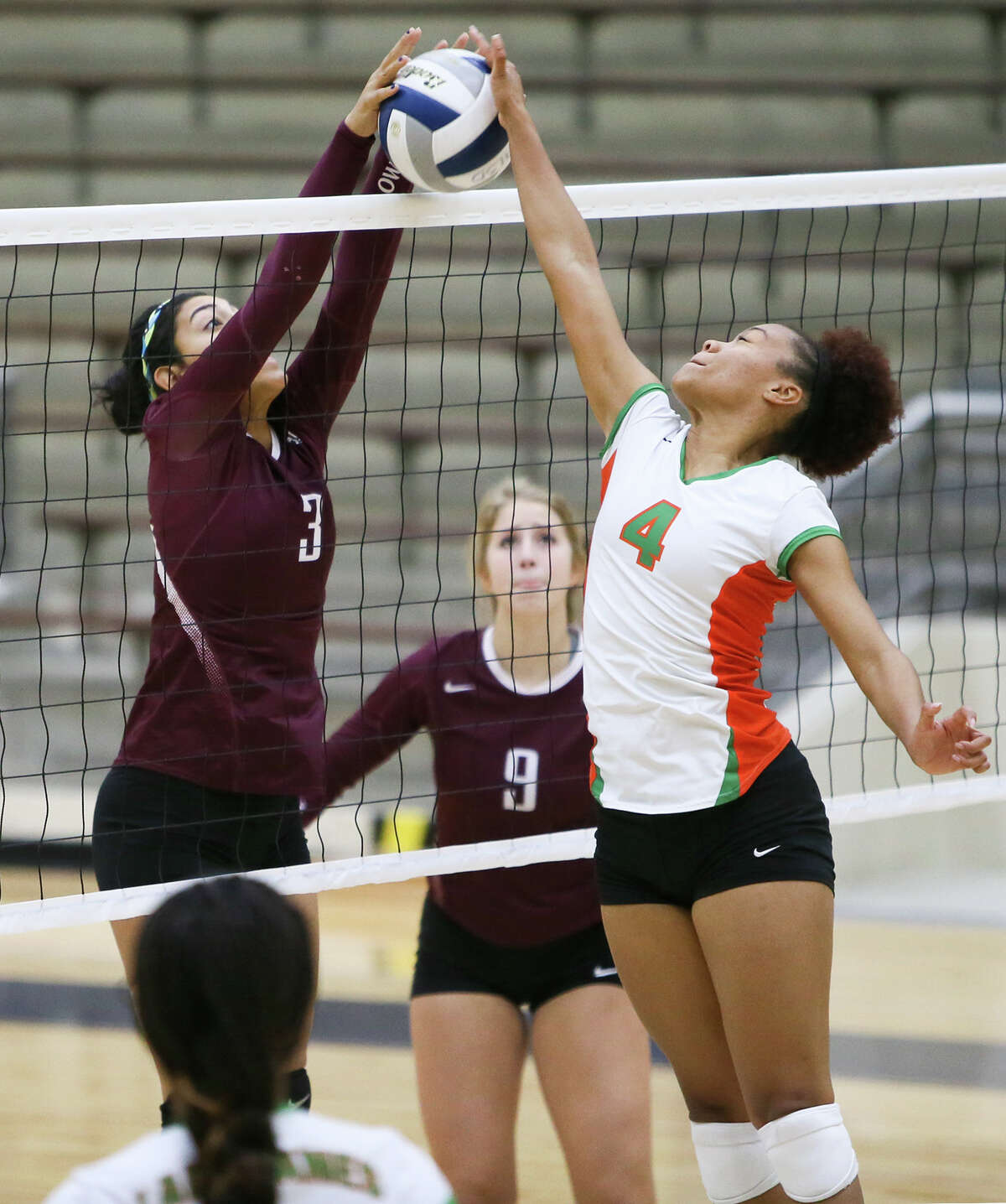 Highlands' Jenelle Rodriguez (left) blocks a shot at the net by Sam Houston's Rita Davis during their match at Alamo Convocation Center on Wednesday, Oct. 14, 2015. Highlands beat Sam Houston in 4 games: 21-25, 25-14, 25-23, 25-13. MARVIN PFEIFFER/ mpfeiffer@express-news.net