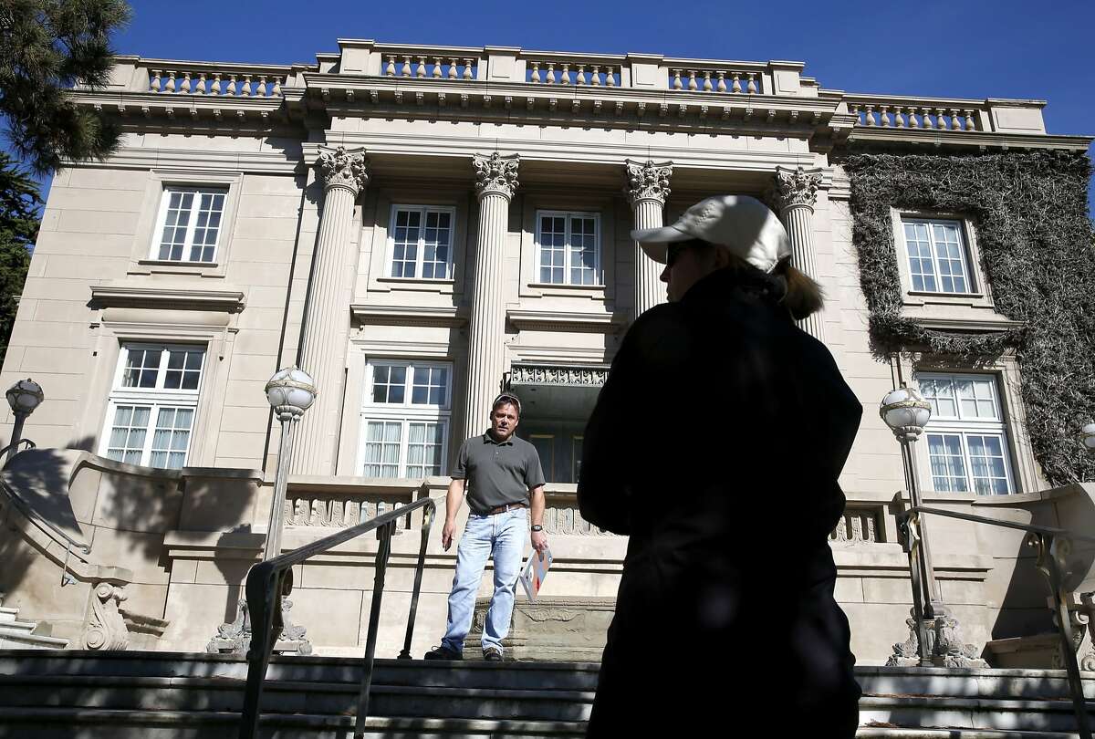 City building inspector Michael Gunnell speaks with Vicki Edwards in San Francisco, Calif. on Tuesday, Oct. 20, 2015, a concerned neighbor who has made several complaints with the city about the abandoned Le Petit Trianon mansion in Presidio Heights. A man was arrested for squatting on the property and allegedly stealing several pieces of artwork.