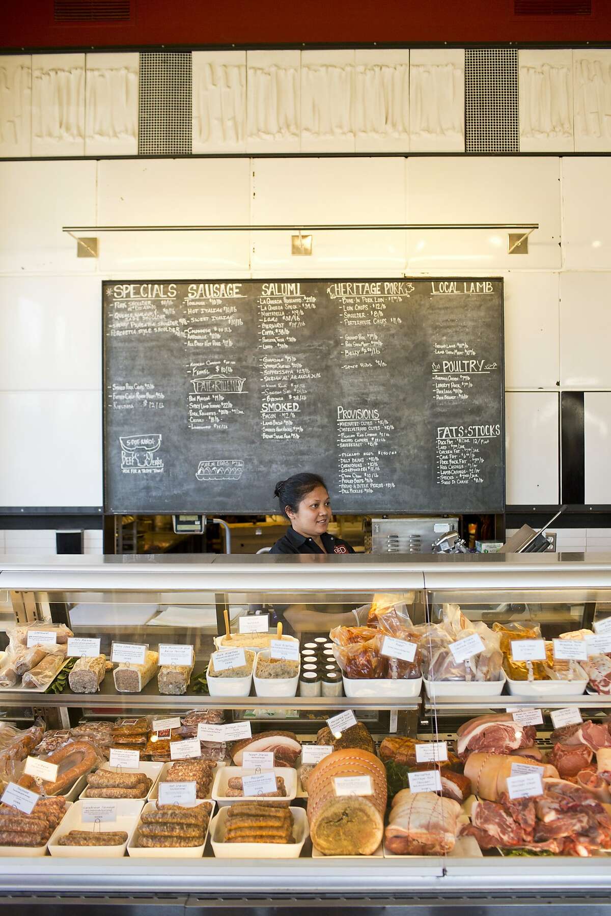 Novita Sobacua takes orders behind the counter at Fatted Calf at the Oxbow Public Market in Napa, Calif., Friday, October 4, 2013.