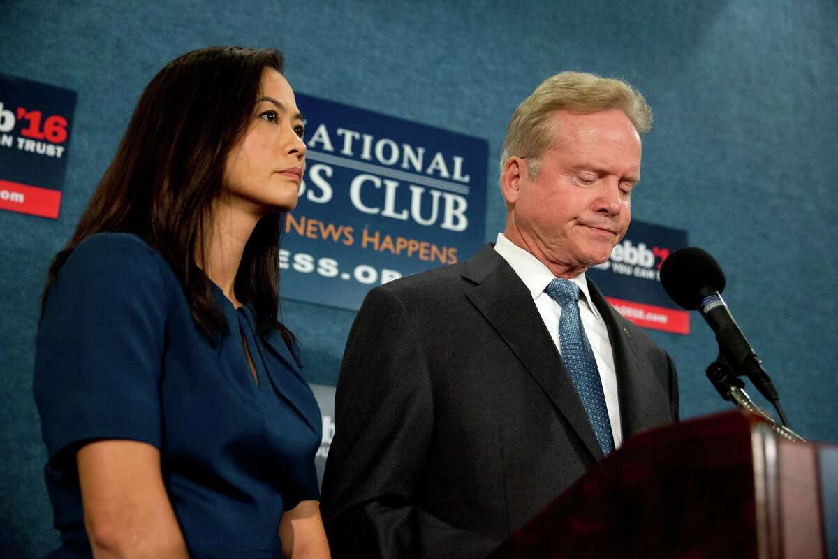 Former Virginia Sen. Jim Webb, accompanied by his wife Hong Le Webb, announced Tuesday he is pulling out of the Democratic race for president during a news conference at the National Press Club in Washington. ﻿