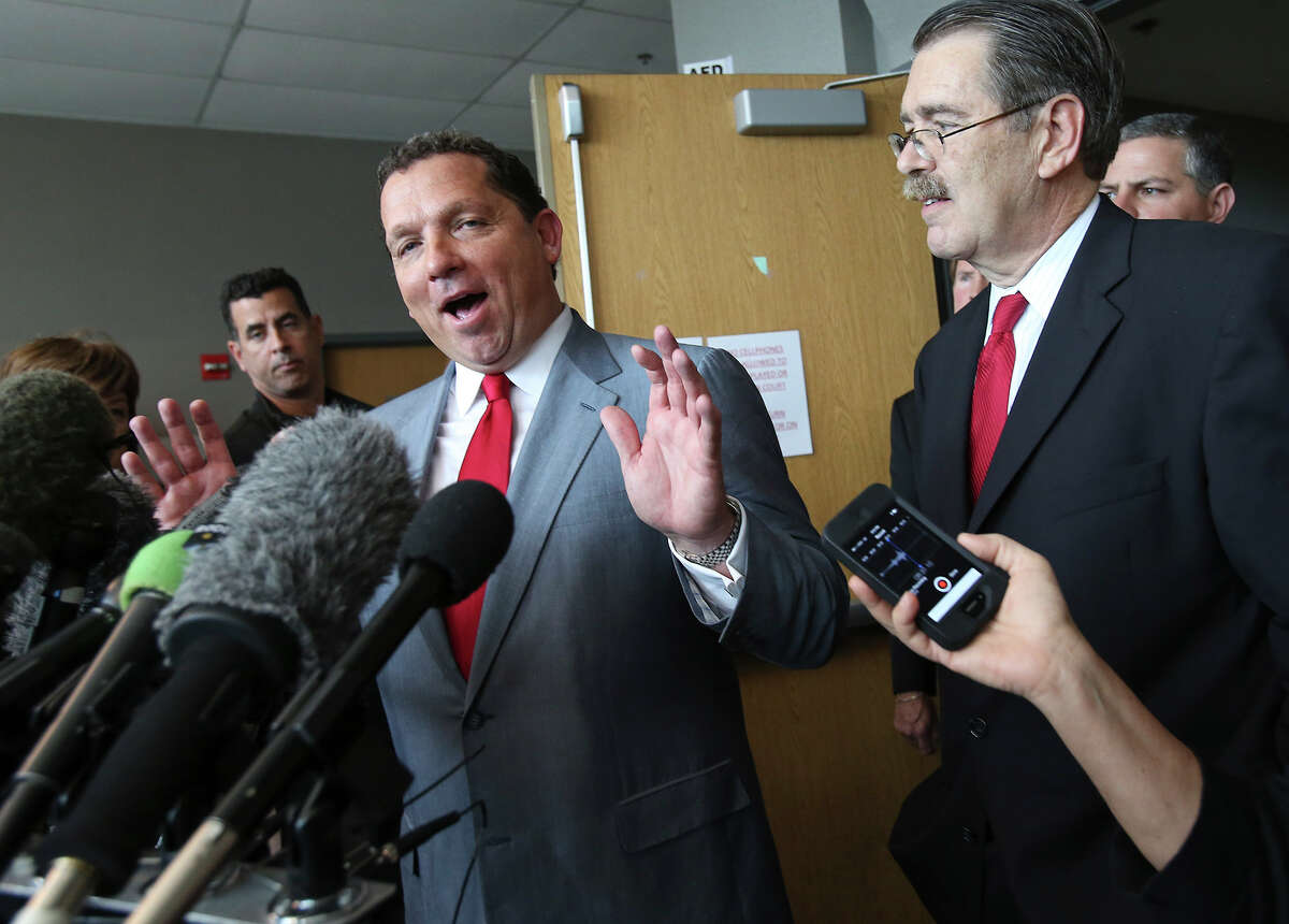 Defense lawyer Tony Buzbee answers questions with attorney David Botsford following Gov. Rick Perry's remarks after appearing at a hearing in the 390th District Court at the Travis County Courthouse on November 6, 2014.