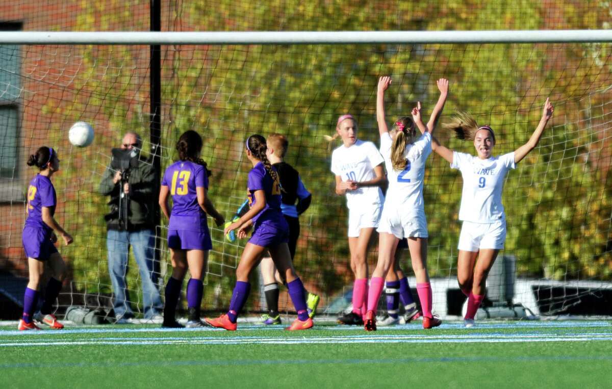 Darien sophomore Charlotte Harmon (9) celebrates after scoring the game’s first goal with teammates Nathalie Bravo (2) and Katie Ramsay (10) in a match against Westhill on Thursday at Darien High School.