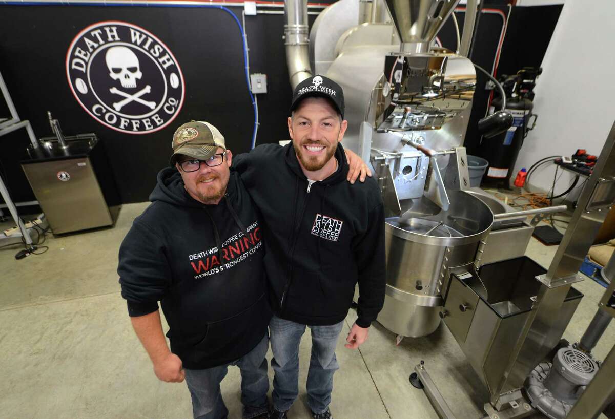 Death Wish Coffee Company research and development head, John Swedish, left, and company owner Michael Brown, right, stand next to the coffee roaster at their production facility Thursday, Oct. 15, 2015, in Round Lake, N.Y. (Will Waldron/Times Union)