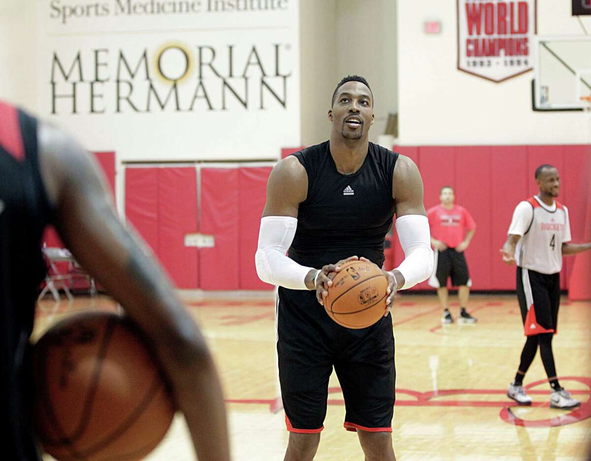 Houston Rockets center Dwight Howard shoots the ball during the Rockets practice at the Toyota Center Tuesday, Sept. 29, 2015, in Houston. ( James Nielsen / Houston Chronicle )