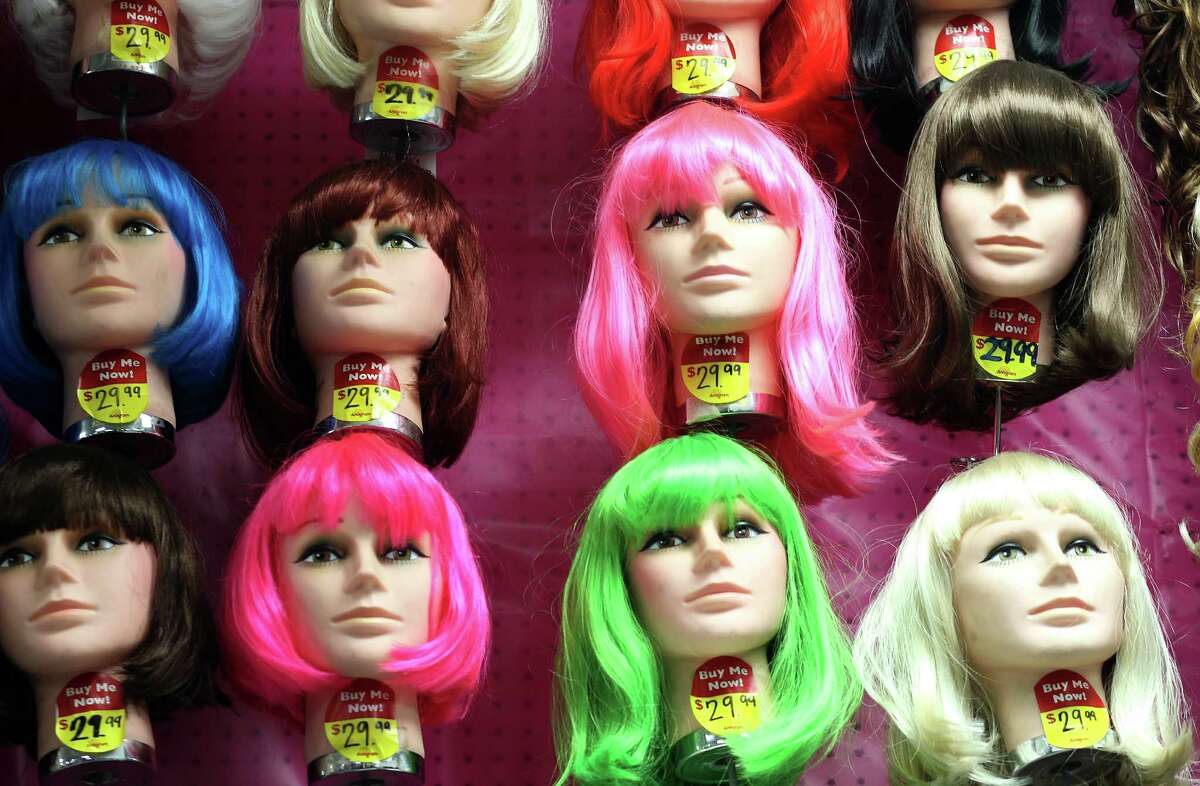 Various colors and styles of wigs adorn a wall at Party Boy, a costume and party supply store that contains everything from decorations to costume rentals to an onsite haunted house, Tuesday, Oct. 20, 2015, in Houston. ( Mark Mulligan / Houston Chronicle )