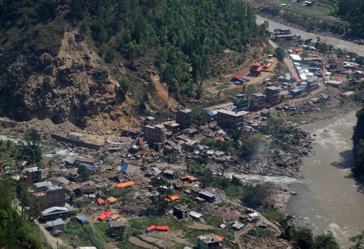 Damaged houses are seen from a helicopter at Charikot, Nepal, Thursday, May 14, 2015, after Nepal was overwhelmed by massive earthquakes.