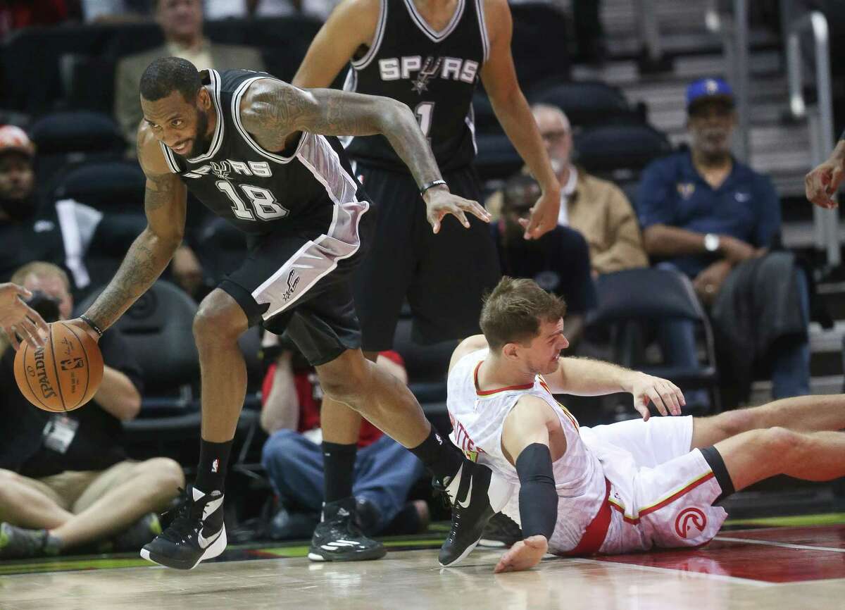 Spurs forward Rasual Butler comes up with a loose ball against Hawks forward Tiago Splitter in the first first half of a preseason game on Oct. 14, 2015, in Atlanta.
