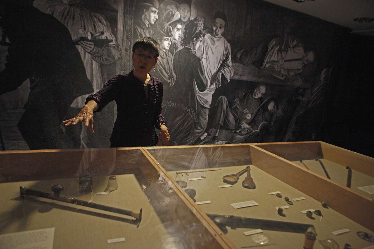 Executive Director Sue Lee talks about the Opium paraphernalia history and perceptions during a tour of Underground Chinatown exhibit located in the lower level of the Chinese Historical Society of America Museum on October 24, 2015.
