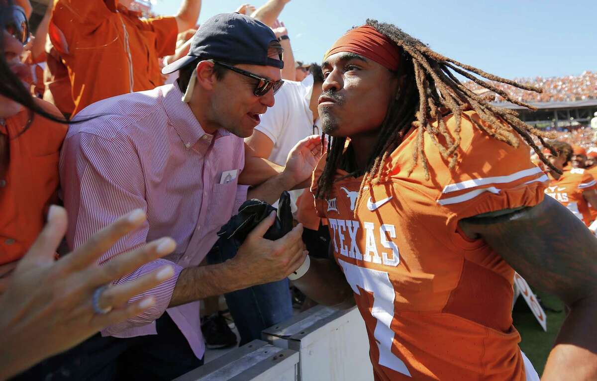 Texas wide receiver Marcus Johnson celebrates with fans after a 24-17 win against Oklahoma at the Cotton Bowl in Dallas on Oct. 10, 2015.