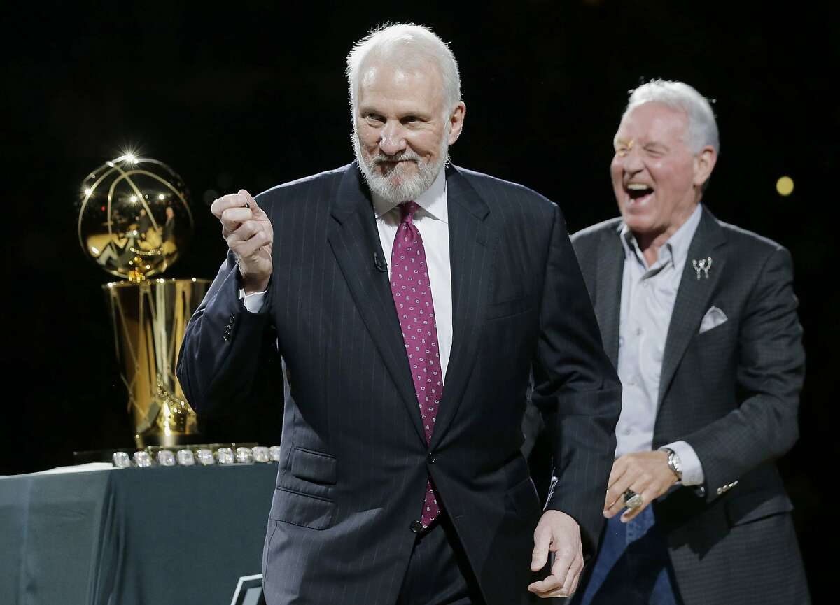 FILE - In this Oct. 28, 2014, file photo, San Antonio Spurs' Gregg Popovich, left, celebrates with owner Peter Holt, right, after they received their NBA championship rings prior to an NBA basketball game between the Spurs and the Dallas Mavericks in San Antonio. Popovich, who has led the San Antonio Spurs to five NBA titles, will replace Mike Krzyzewski as the U.S. basketball coach following the 2016 Olympics. (AP Photo/Eric Gay, File)