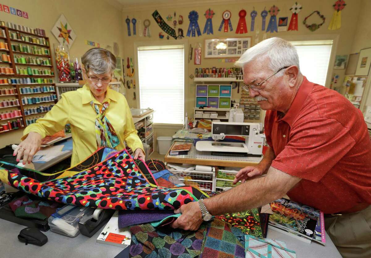 Libby Lehman and her husband, Lester Lehman, look through a stack of quilts in her home studio. She was a leader in her field until she was stopped by a brain aneurysm and stroke two years ago.