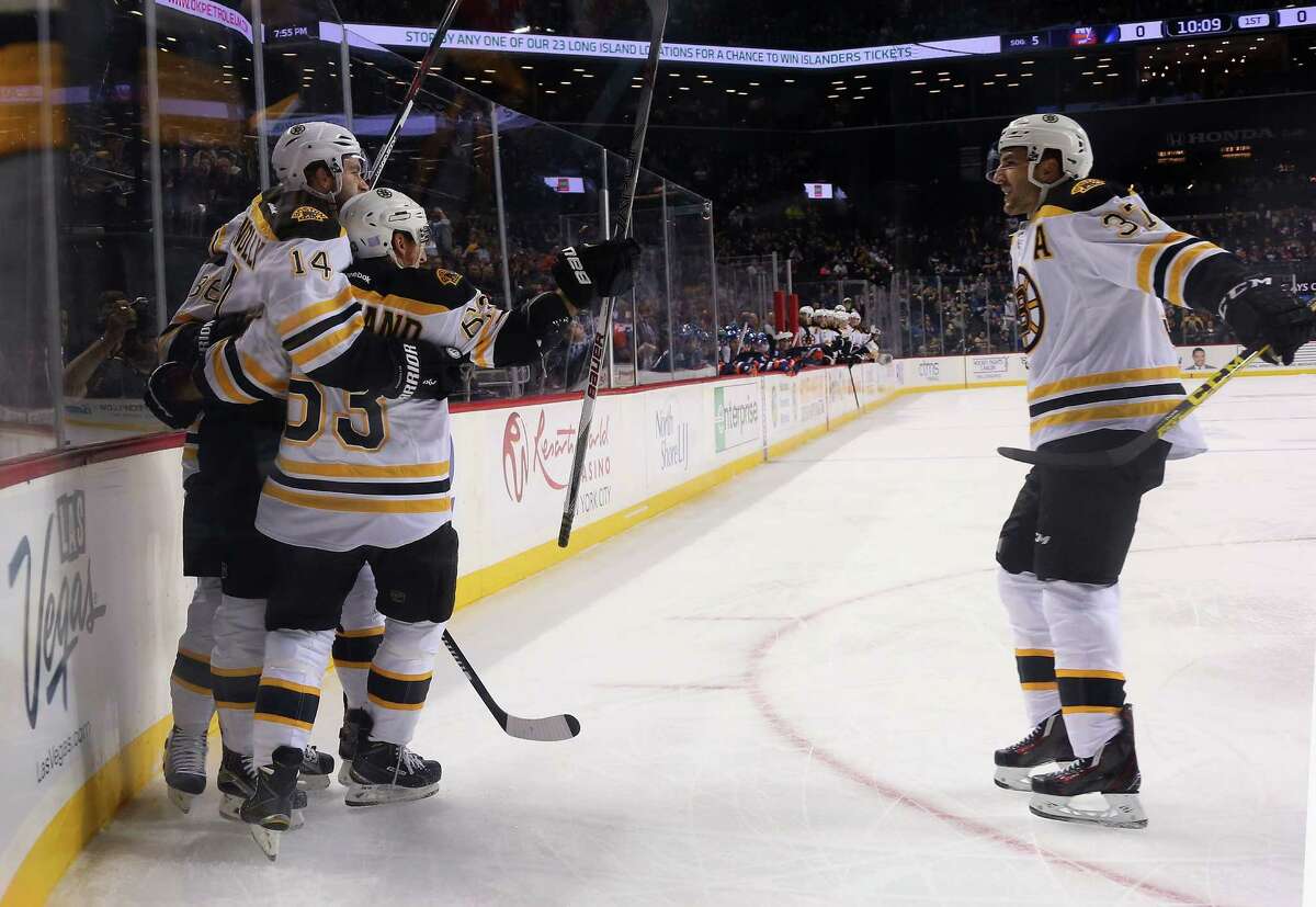 NEW YORK, NY - OCTOBER 23: Brett Connolly #14 of the Boston Bruins (l) celebrates his goal at 9:14 of the first period against the Boston Bruins at the Barclays Center on October 23, 2015 in the Brooklyn borough of New York City. (Photo by Bruce Bennett/Getty Images) ORG XMIT: 574711995