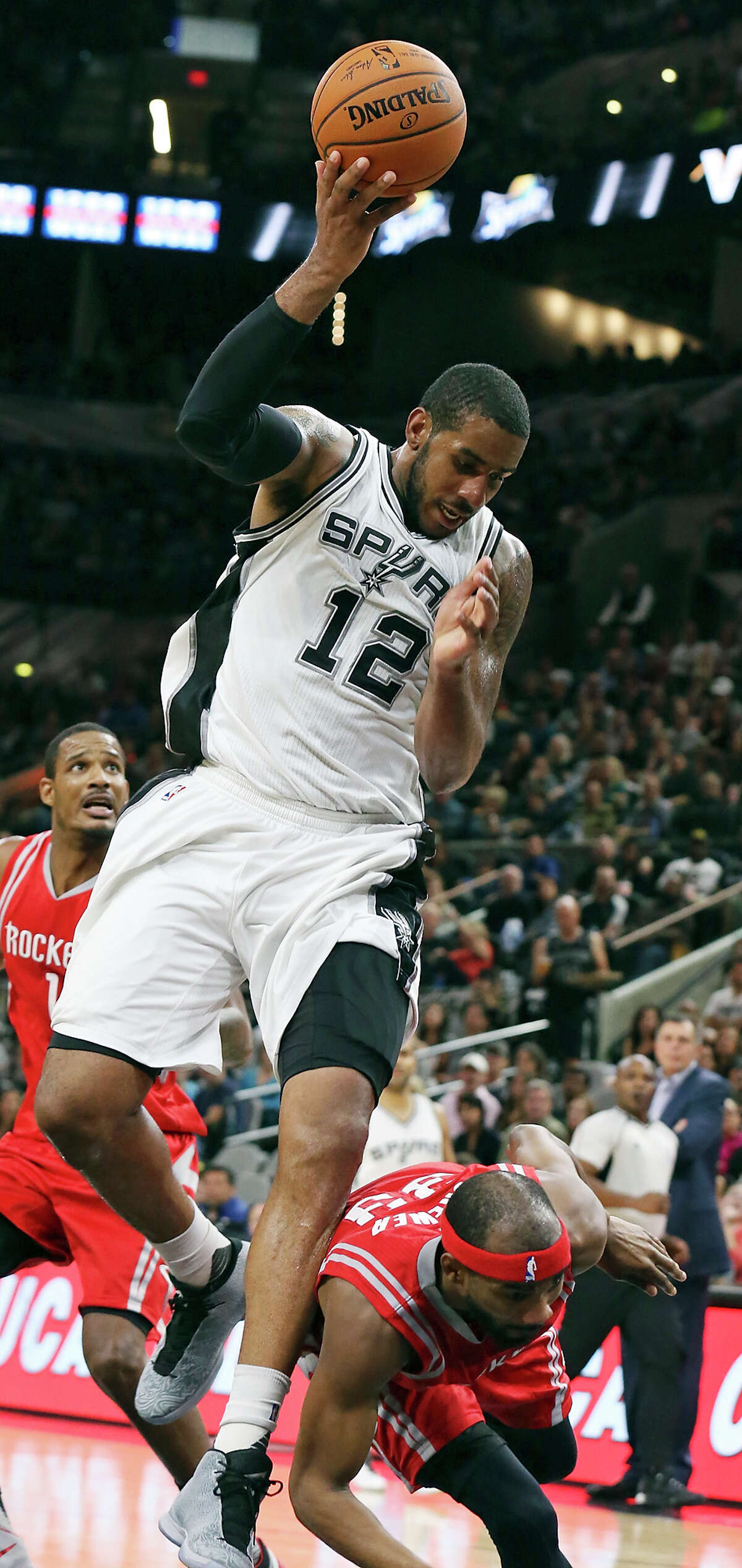 San Antonio Spurs' LaMarcus Aldridge is fouled by Houston Rockets' Corey Brewer during second half action Friday Oct. 23, 2015 at the AT&T Center. The Spurs won 111-86.