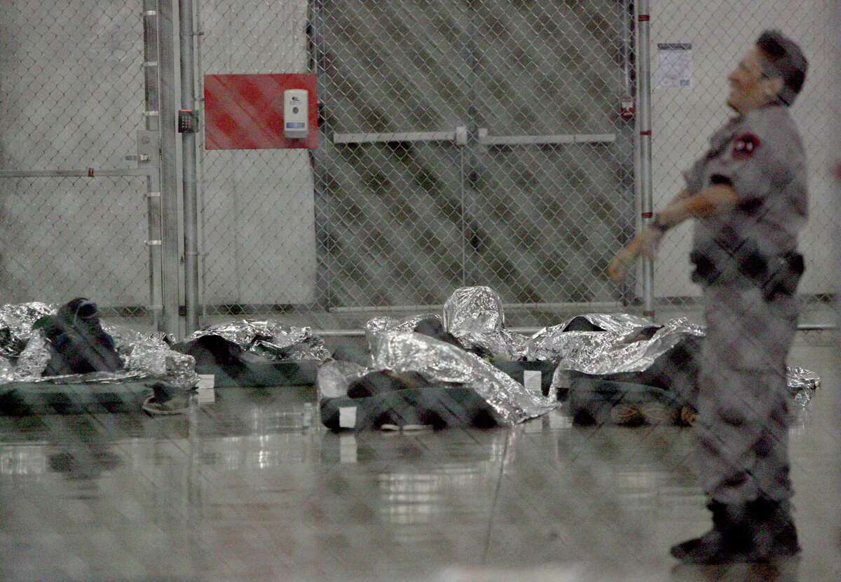 MCALLEN,Tx-Immigrants who were recently apprehended sleep on floor mats Wednesday Aug. 26. 2015 at the US Border Patrol Processing Center in McAllen . Photo by Delcia Lopez dlopez@themonitor.com