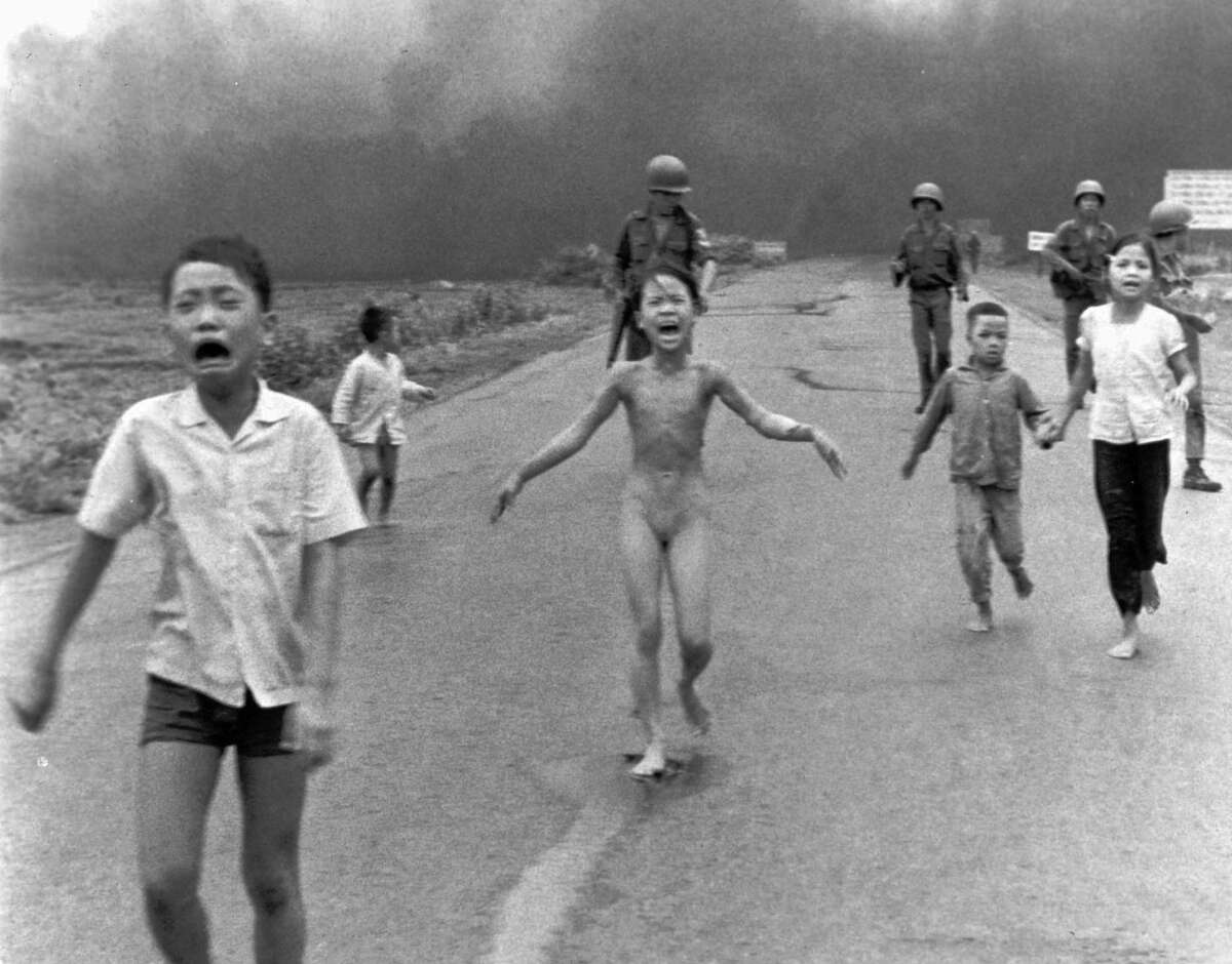 A group of terrified children, including 9-year-old Kim Phuc as they flee after an accidental aerial napalm attack on Trang Bang, South Vietnam.